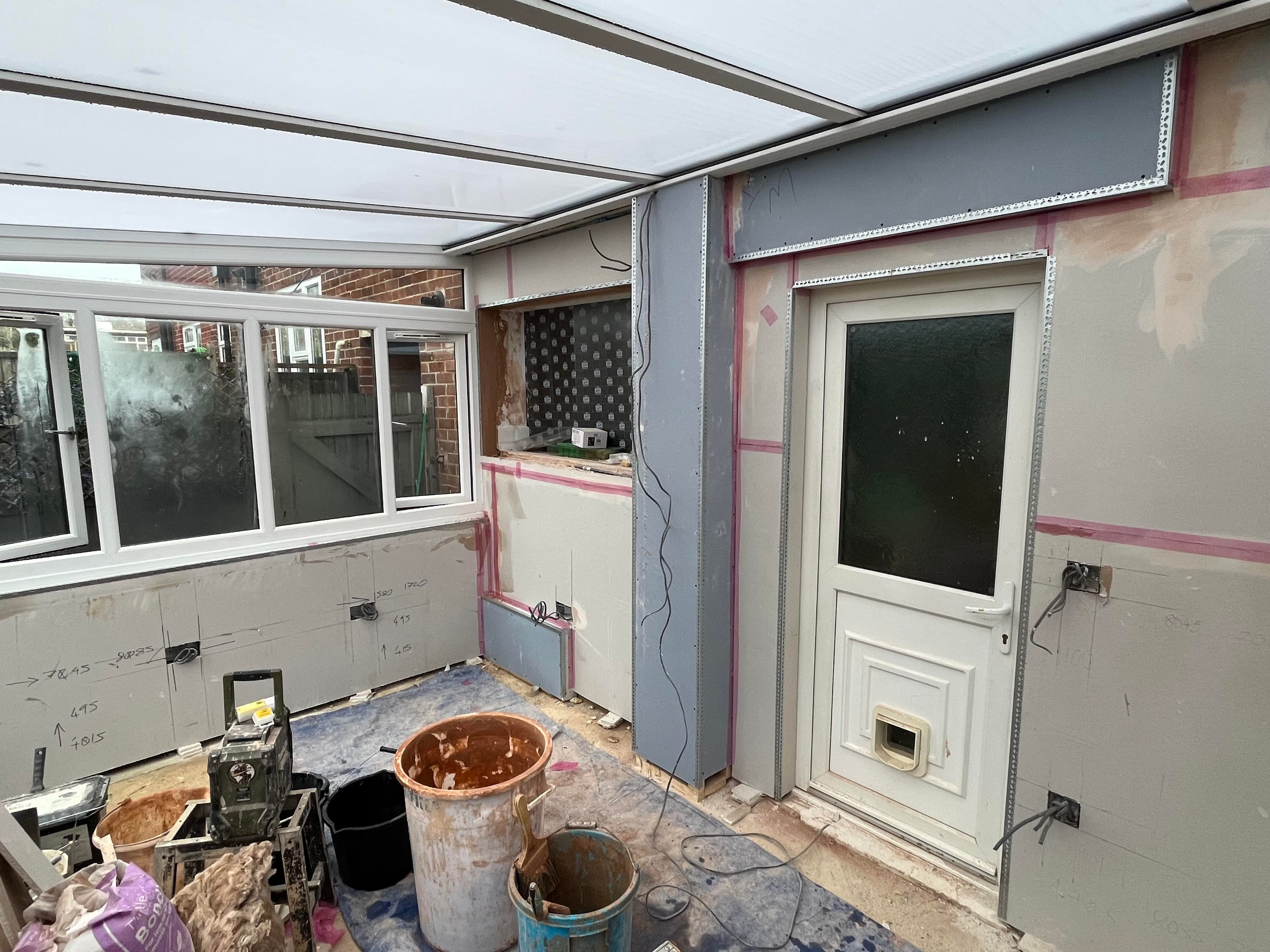 David Clement plastering an interior room
